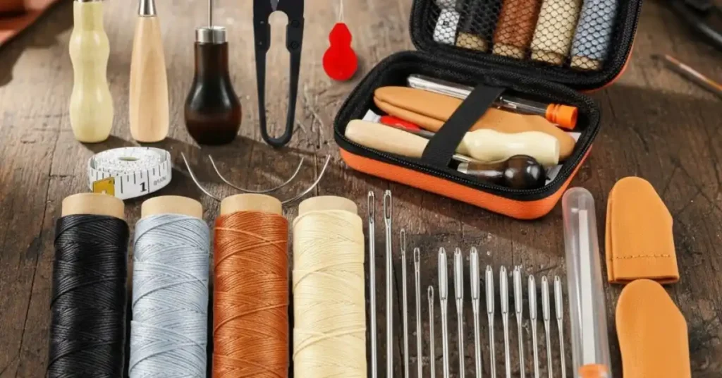 Close-up of the PLANTIONAL 31-piece leather working kit, including three wooden-handled awls, four spools of pro waxed thread, an assortment of large eye needles, and an orange travel case.